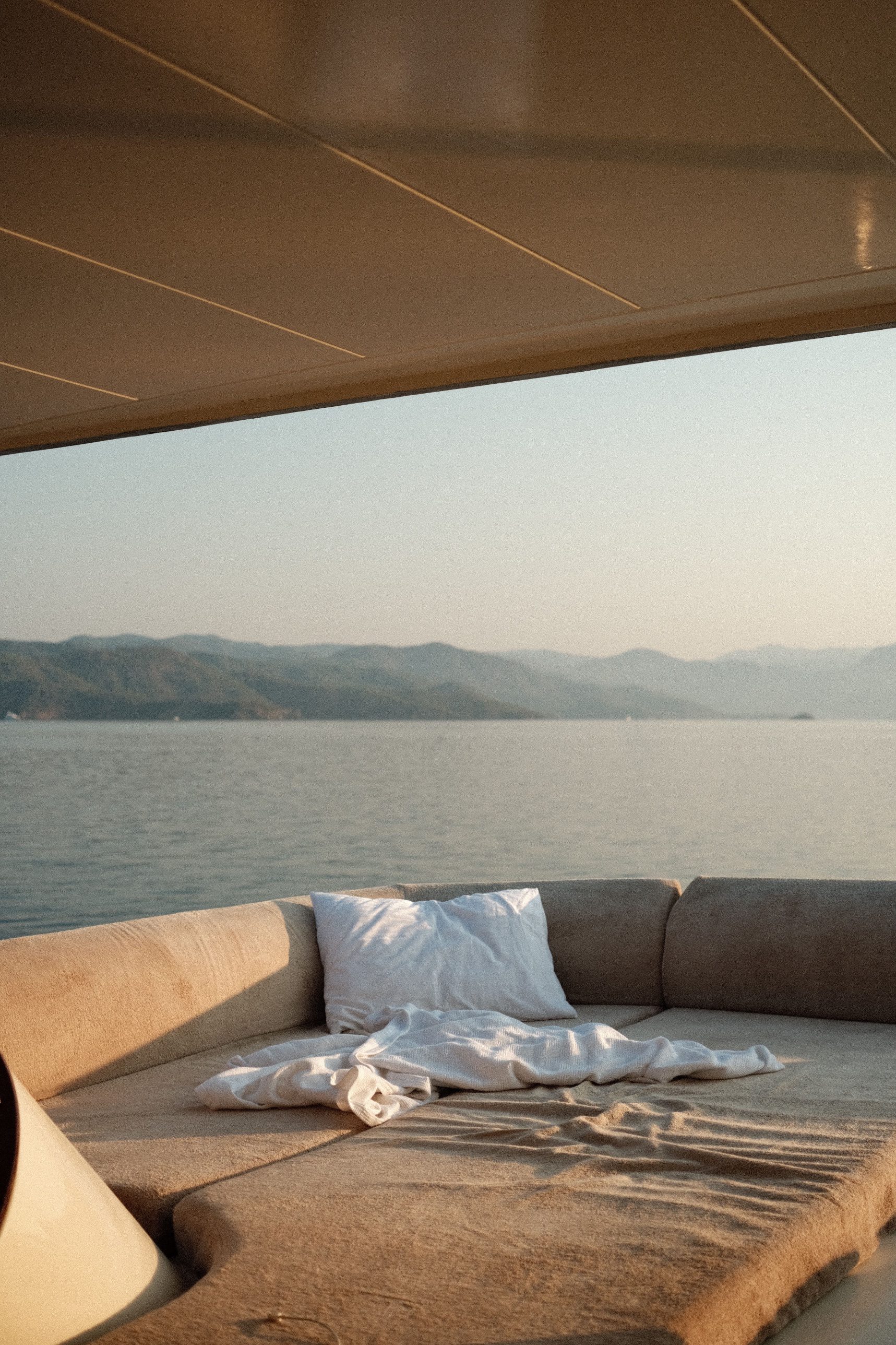 Daybed on a yacht deck facing the sea