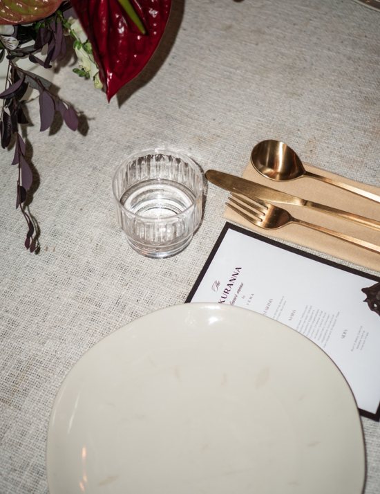Set table with gold cutlery and menu