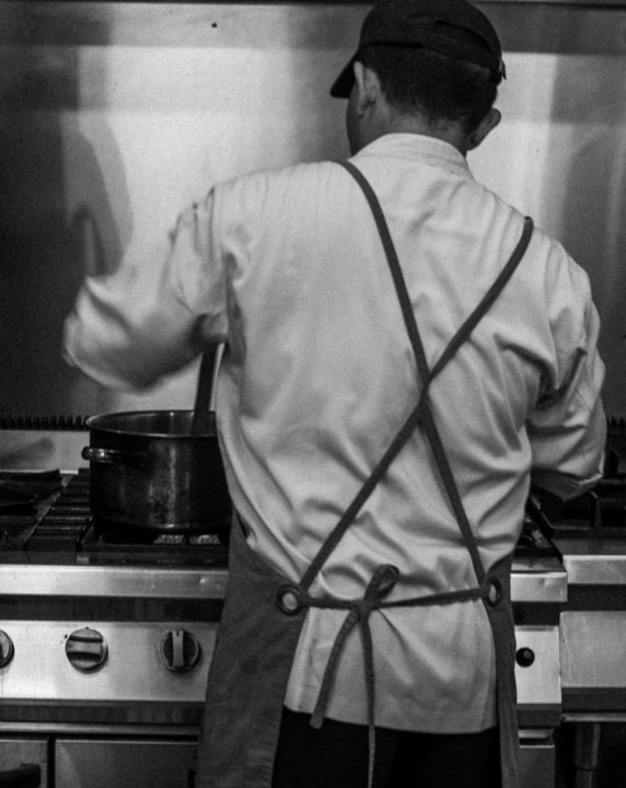 Chef cooking, in black and white