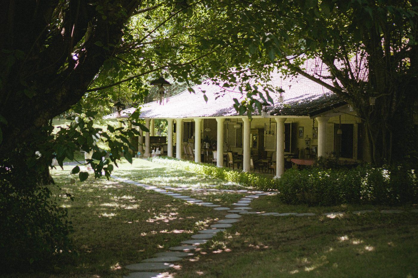 Colonial villa with columned veranda and a stepping-stone path